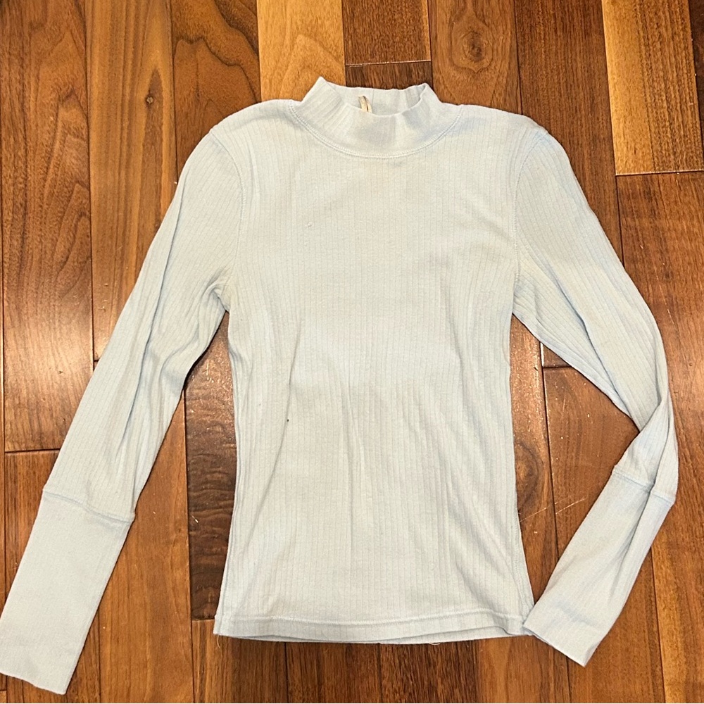 FP Movement Laura Long Sleeve Rib Top in a light blue or mint-toned color.